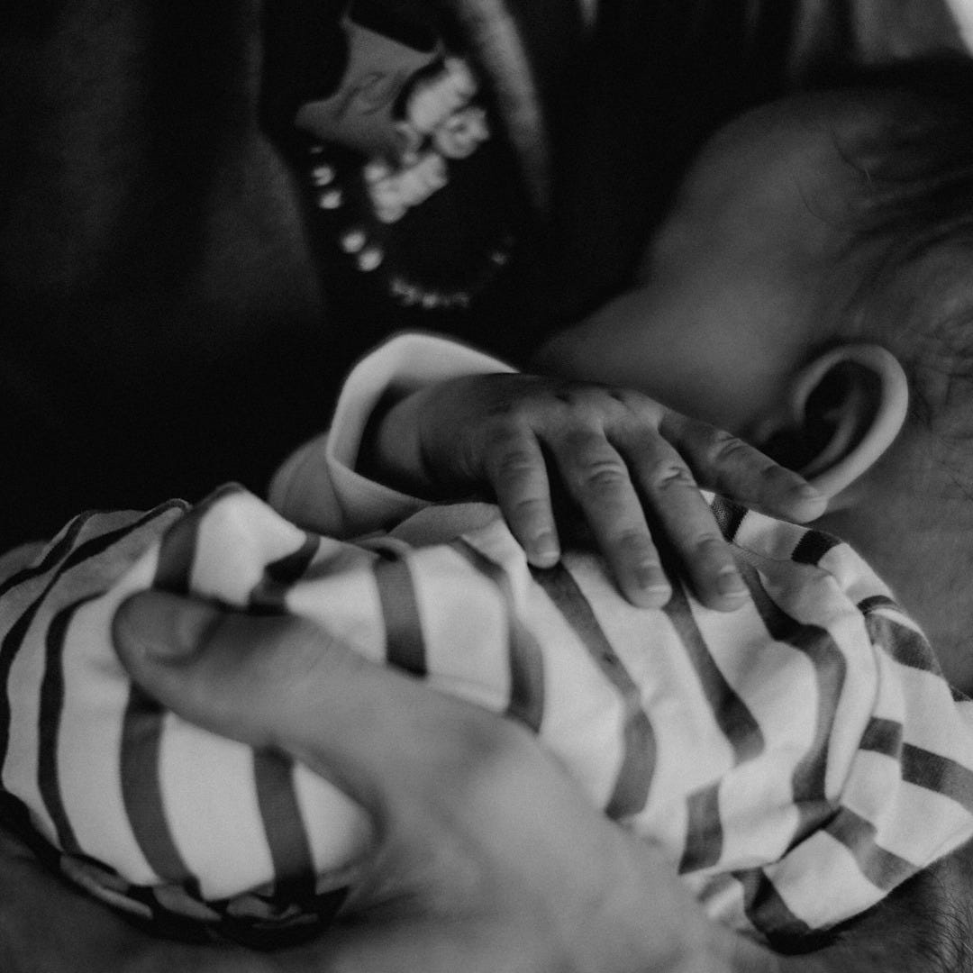 grayscale photo of person holding stripe textile
