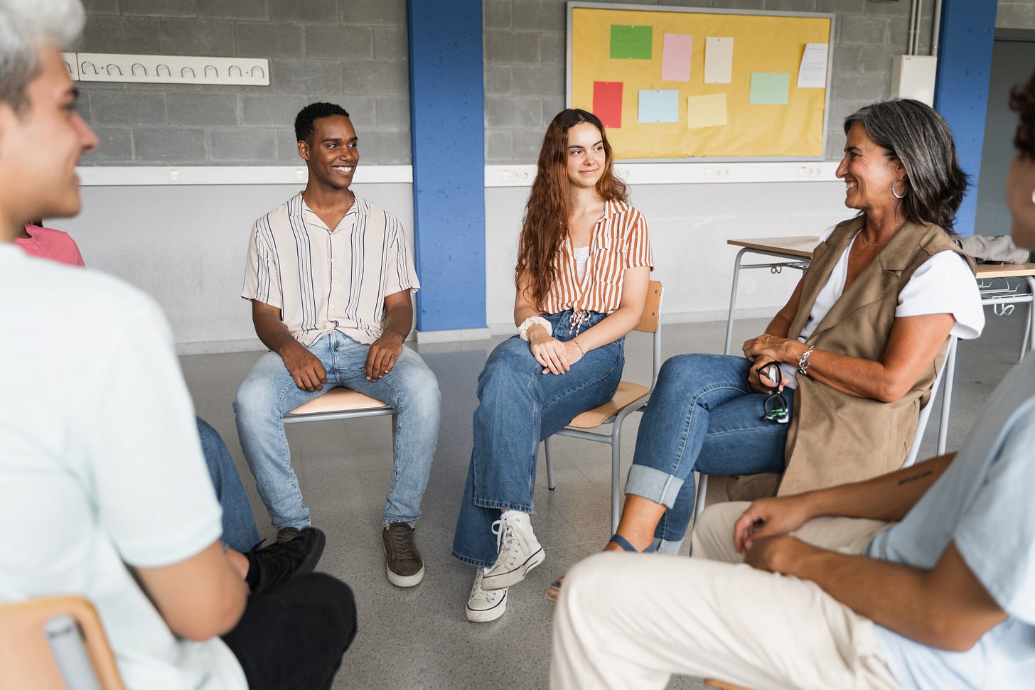 Teacher having a discussion with a group of students