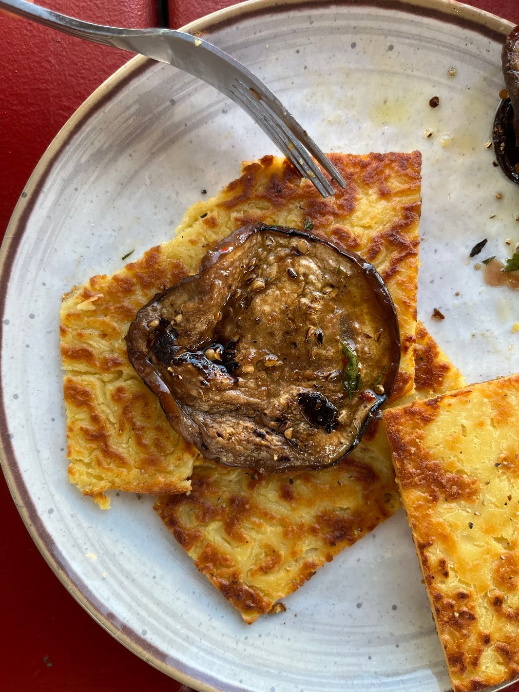 Torta de ceci on a plate with eggplant