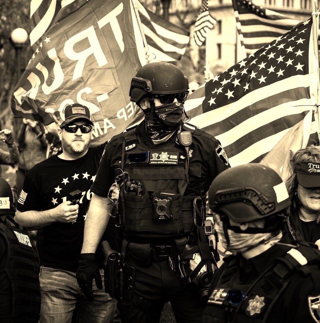 man in black police uniform holding us a flag