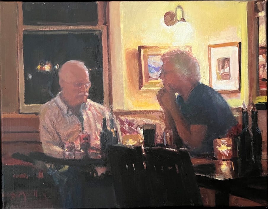 A couple of men sitting at a table

Description automatically generated