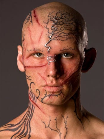 Photo of male lead from Beastly showing him in his "ugly" form, with scars and tattoos and weird little lines all over his face.