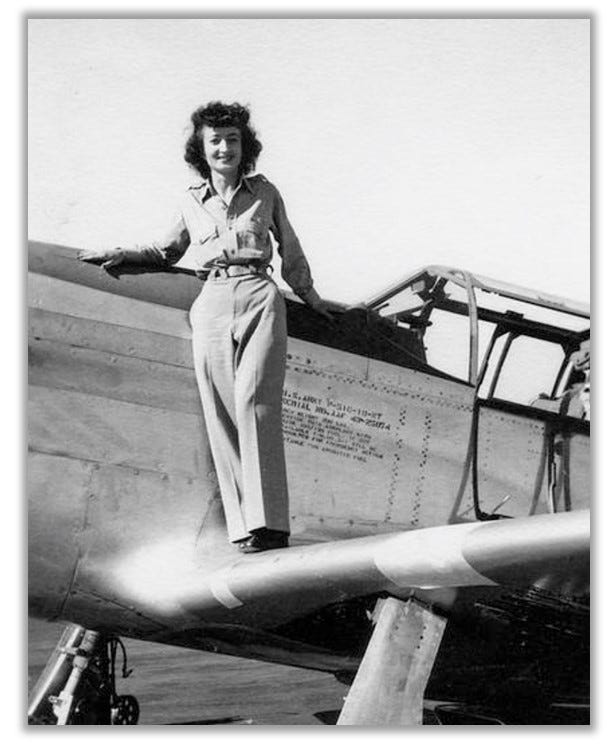 Vi is pictured standing on the wing of her plane.