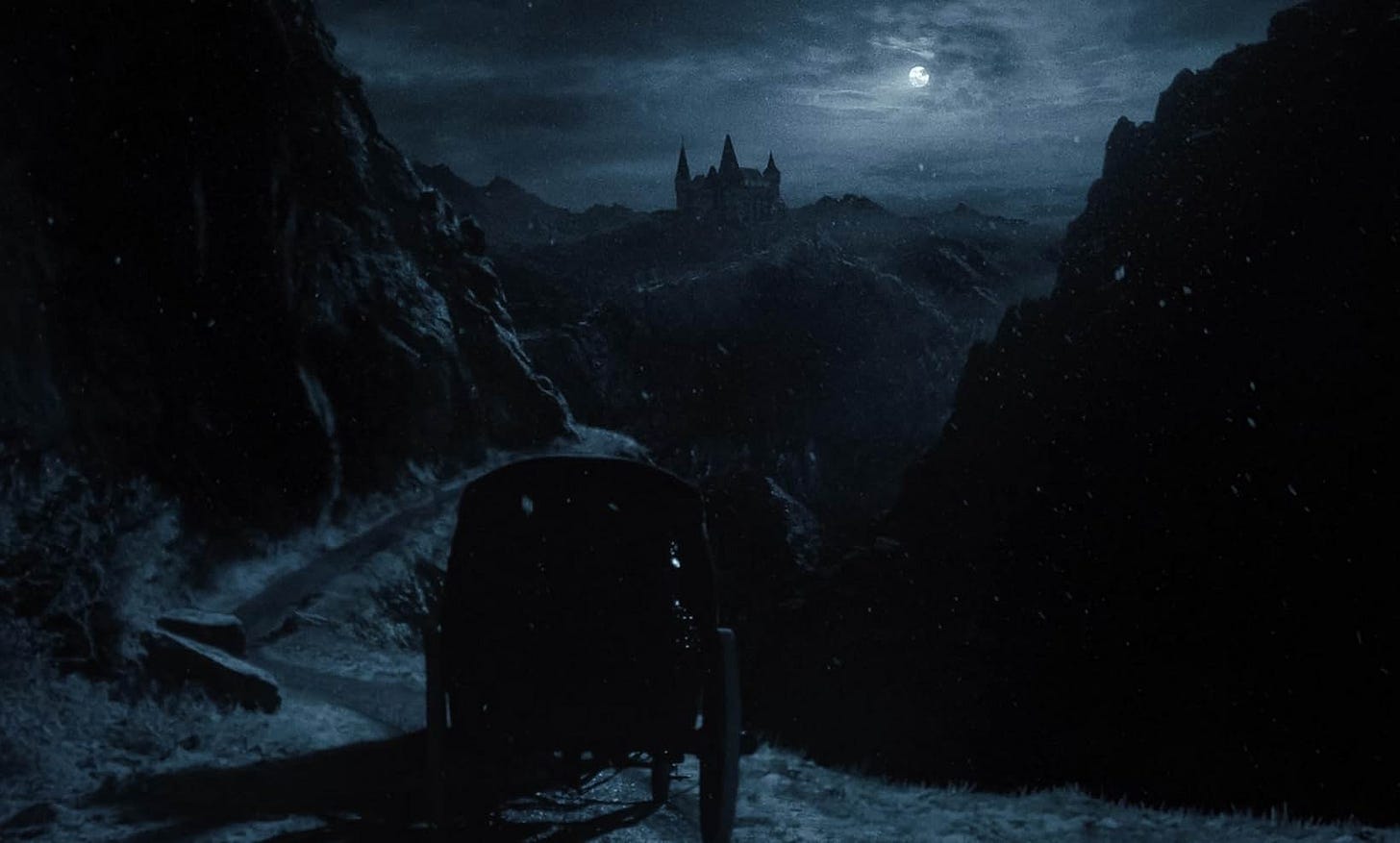 A still from the film. A carriage travels towards a distant castle in the mountains. 