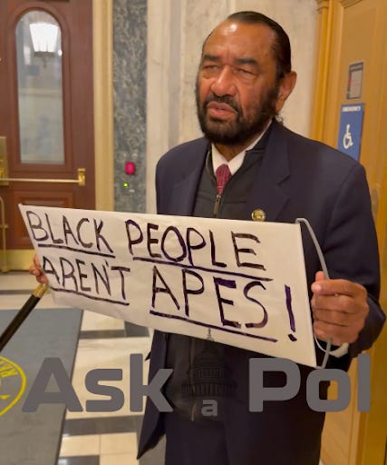 A man in a suit holds up an anti-racist ape dipction of the Obamas sign at SOTU Photo: Matt Laslo © www.askapolpolitics.com A man in a suit holds up an anti-racist ape dipction of the Obamas sign at SOTU Photo: Matt Laslo © www.askapolpolitics.com