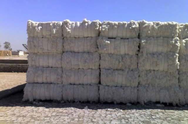This may contain: a pile of white sandbags sitting on top of a sidewalk This may contain: a pile of white sandbags sitting on top of a sidewalk