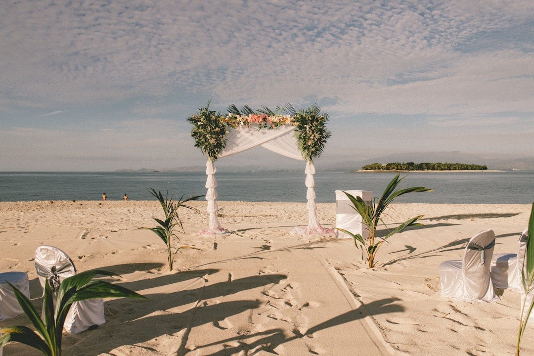 a wedding setup on the beach with a view of the ocean a wedding setup on the beach with a view of the ocean