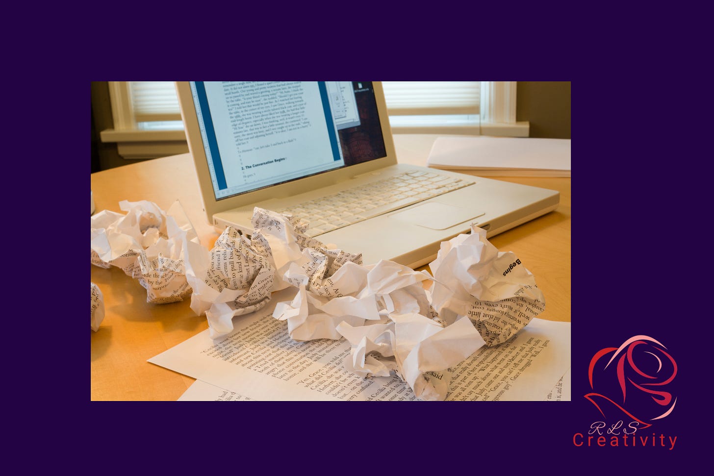 Crumpled sheets of paper sitting on top of a printed article, sitting beside a laptop computer with an editing screen open. Crumpled sheets of paper sitting on top of a printed article, sitting beside a laptop computer with an editing screen open.