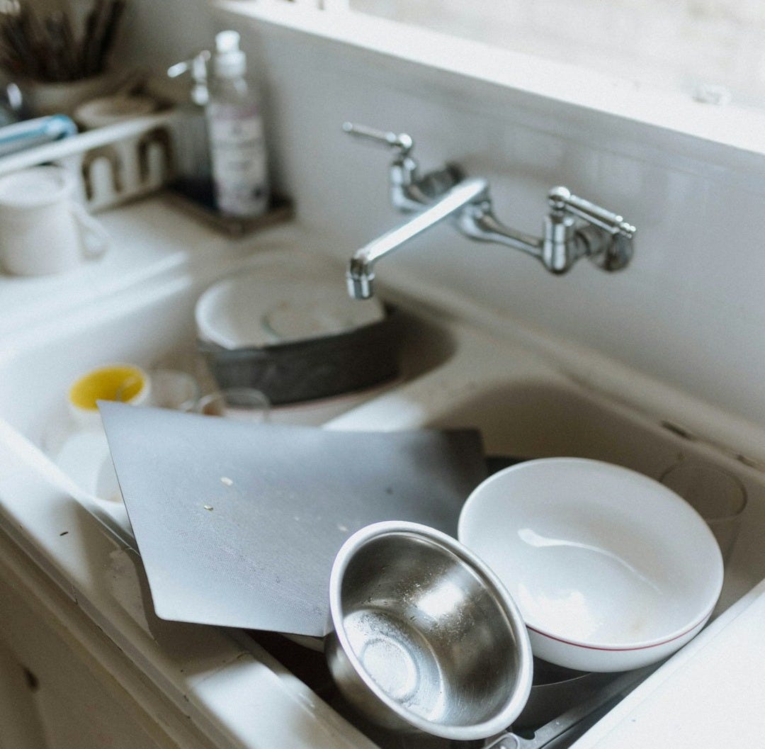 a sink with a couple of dishes on it