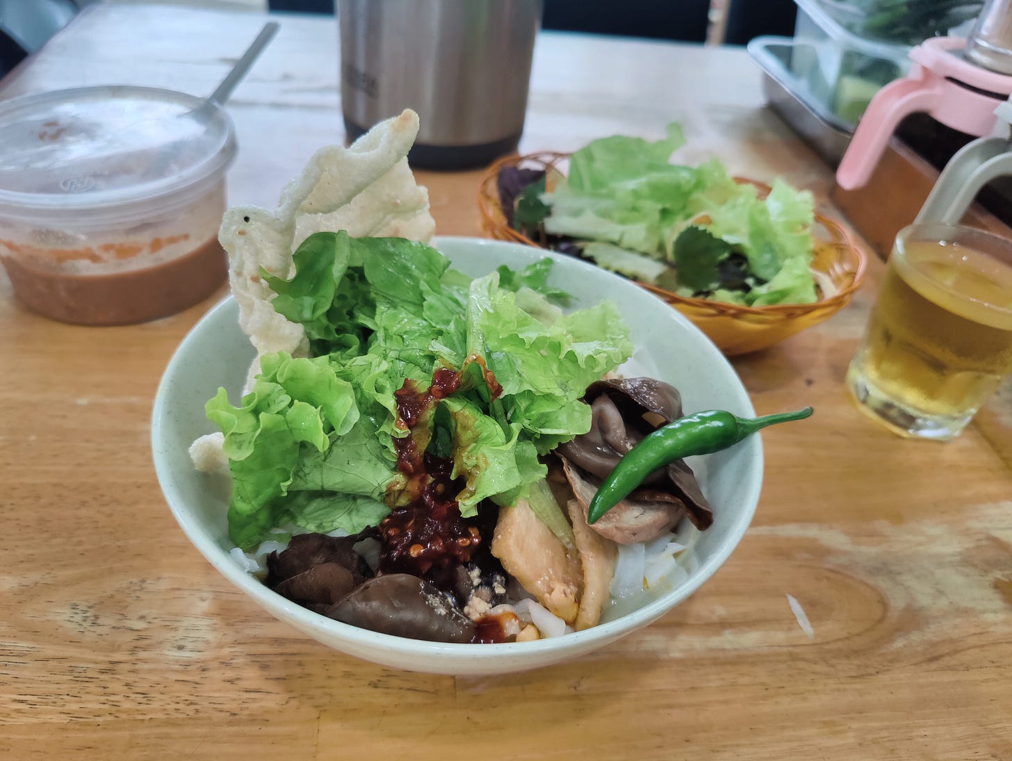 bowl of noodles and greens and red chili jam