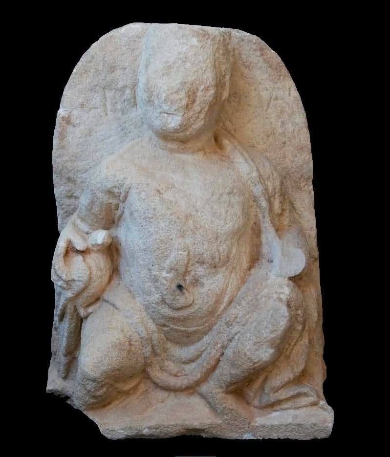 The limestone funerary stele found at Marina El Alamein, showing a seated man holding a bird. 