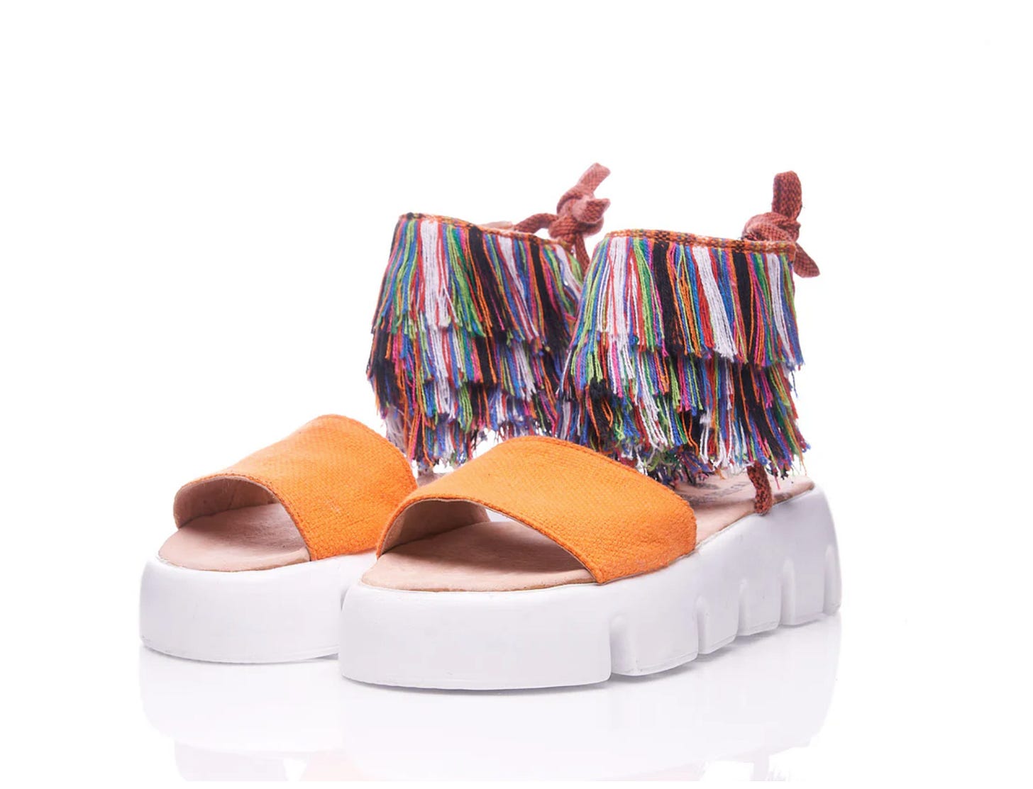 A pair of colorful shoes inspired by the Oaxacan folk figure, the tiliche. A pair of colorful shoes inspired by the Oaxacan folk figure, the tiliche.