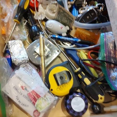 This is a mature and well tended American Junk Drawer. Note that it has  produced not only matches and two tape measures but both a Phillips head  and flat head screw driver.