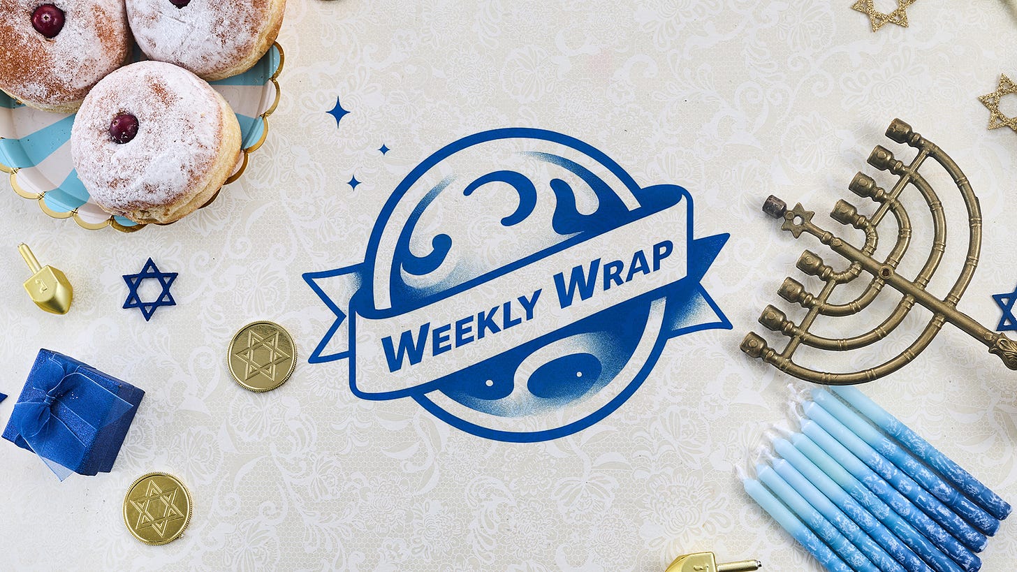 A flat-lay Hanukkah scene with sufganiyot dusted in powdered sugar, a brass menorah, blue candles, dreidels, chocolate gelt, and small gifts arranged around a blue “Weekly Wrap” logo on a patterned background. A flat-lay Hanukkah scene with sufganiyot dusted in powdered sugar, a brass menorah, blue candles, dreidels, chocolate gelt, and small gifts arranged around a blue “Weekly Wrap” logo on a patterned background.