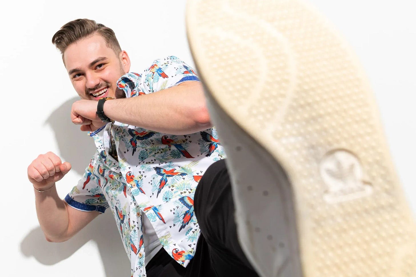 A man doing front-kicking exercises and laughing
