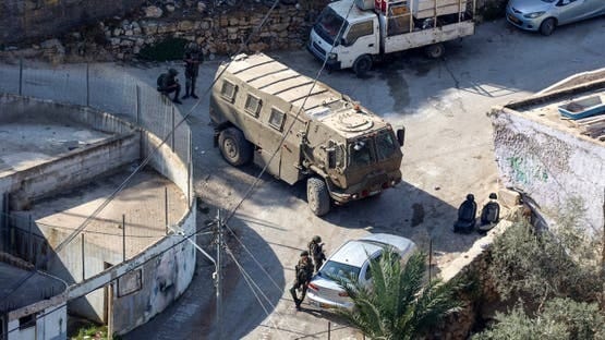 Israeli soldiers take positions in the occupied West Bank village of Qatanna ahead of the demolition of houses belonging to Palestinians on November 6, 2025. (AFP)