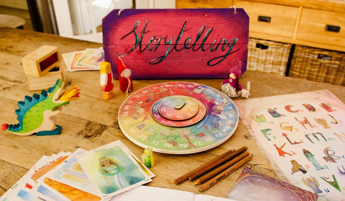 A vibrant storytelling setup featuring wooden toys, colorful cards, and a spinning wheel on a rustic table, inviting creativity and imagination.