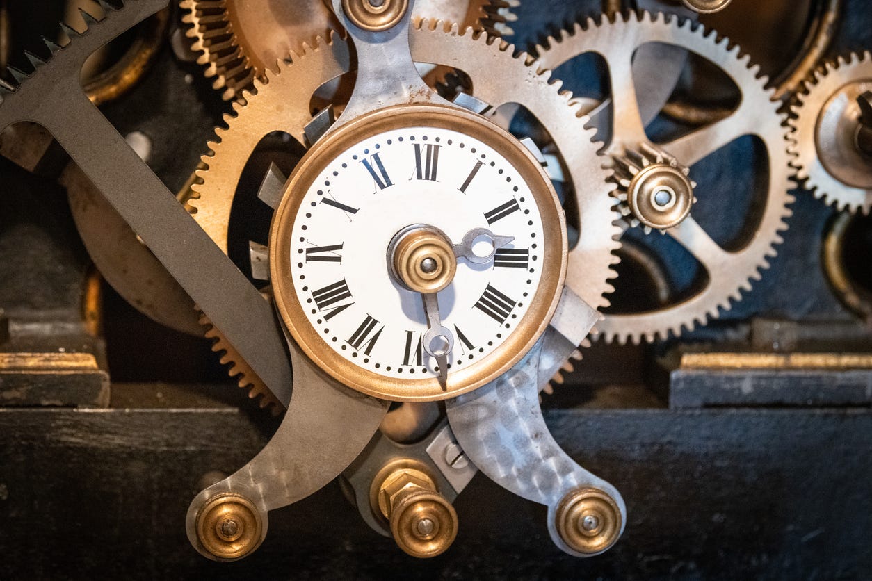 Old clock driving the mechanism for triggering the bells of a church in France
