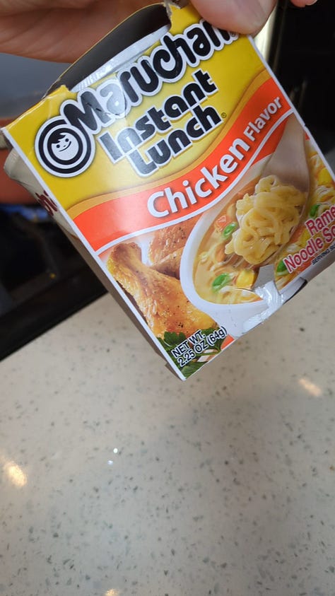 Classic chicken instant ramen cup being opened, cooked, and held up by chopsticks.