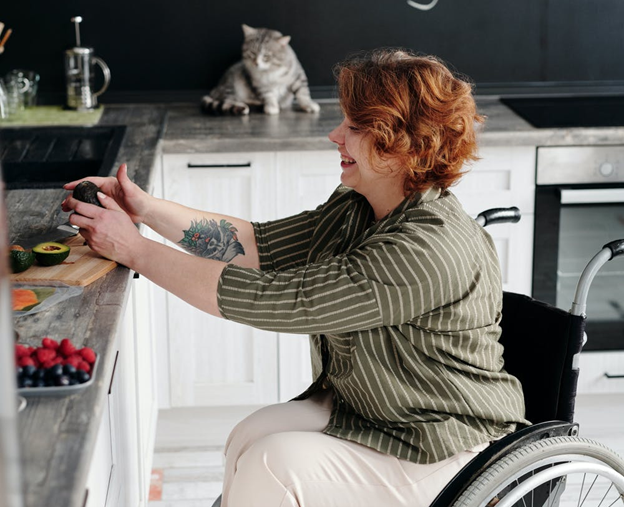 Woman Sitting on Wheelchair While Holding Avocado Woman Sitting on Wheelchair While Holding Avocado