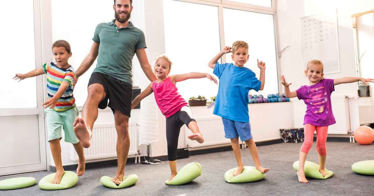 Children doing balance exercises with their coach