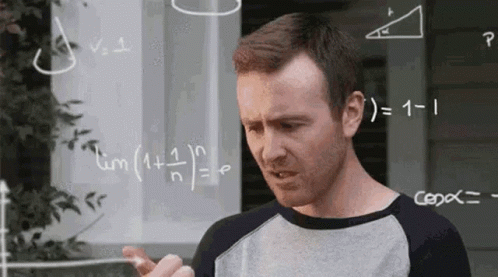 a man is standing in front of a white board with math equations on it . a man is standing in front of a white board with math equations on it .