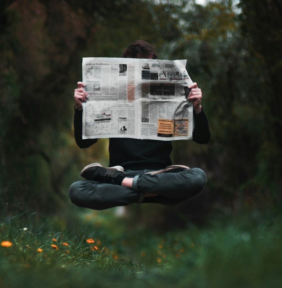 person holding a news paper during daytime person holding a news paper during daytime
