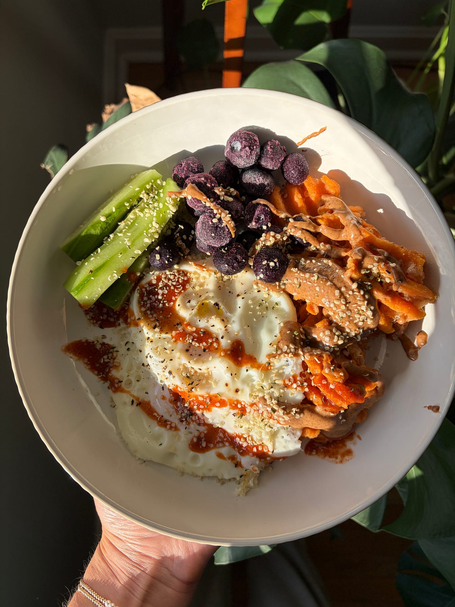 This sweet and savory breakfast bowl is made with crispy air fryer sweet potato fries, fried eggs, fresh cucumber, and frozen blueberries — topped with almond butter, sriracha, and hemp hearts. A high-protein, gluten-free, dairy-free breakfast ready in just 20 minutes.