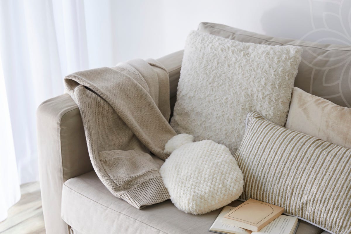 Soft natural light entering an empty, minimal interior space, creating gentle shadows and a sense of quiet stillness, illustrating rest that arrives without effort or activity.