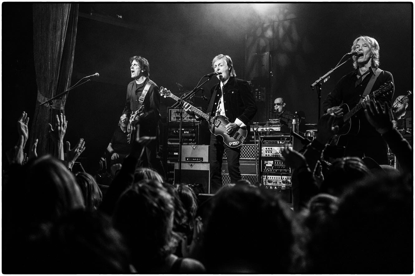 May be a black-and-white image of 5 people and crowd