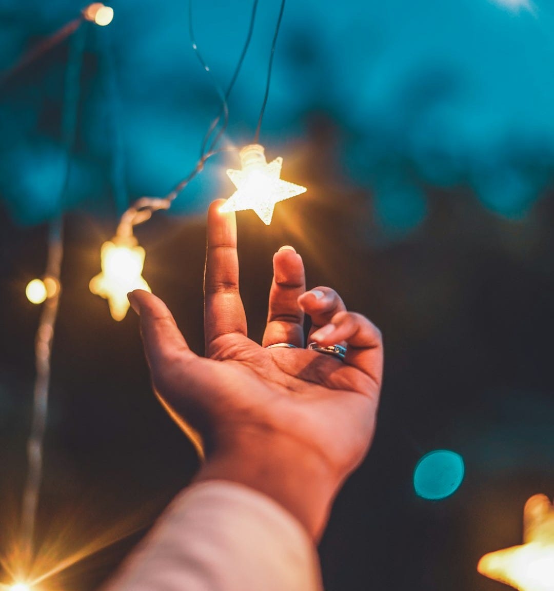 a person holding a star in their hand a person holding a star in their hand