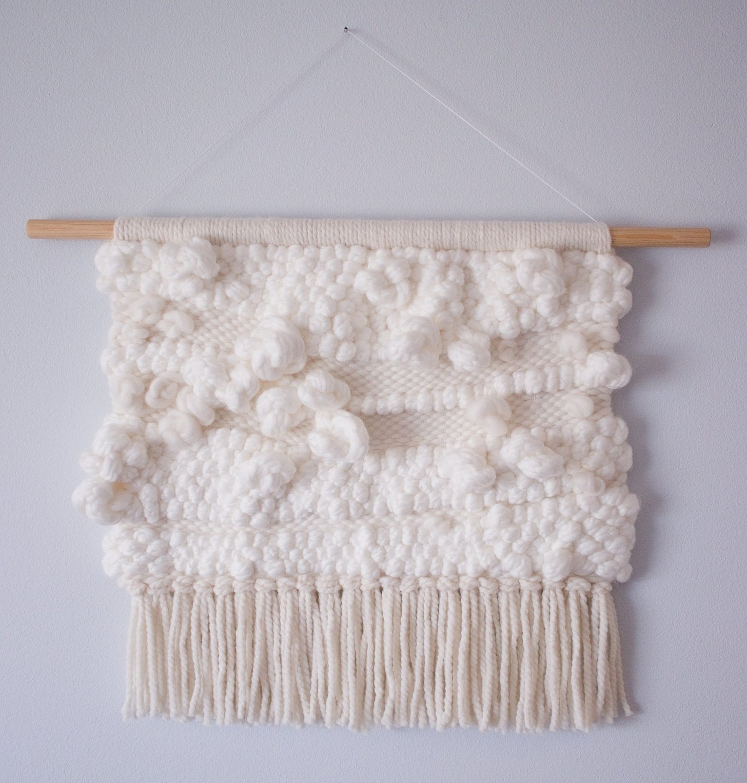 White weaving with big fluffy knots. I made this in 2021. White weaving with big fluffy knots. I made this in 2021.