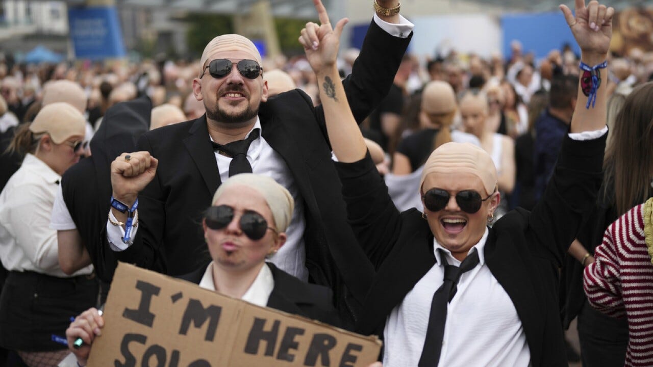 White shirts. Black ties. Bald caps. Pitbull's fans party like clones  worldwide