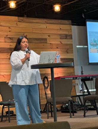 Female conference speaker presenting at podium