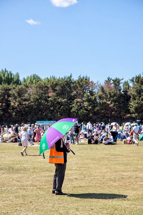 Three scenes from The Queue on a sunny day: a woman shading herself with a yellow umbrella, an ice cream truck with left luggage behind it, and a steward with a Wimbledon umbrella surveying the crowd