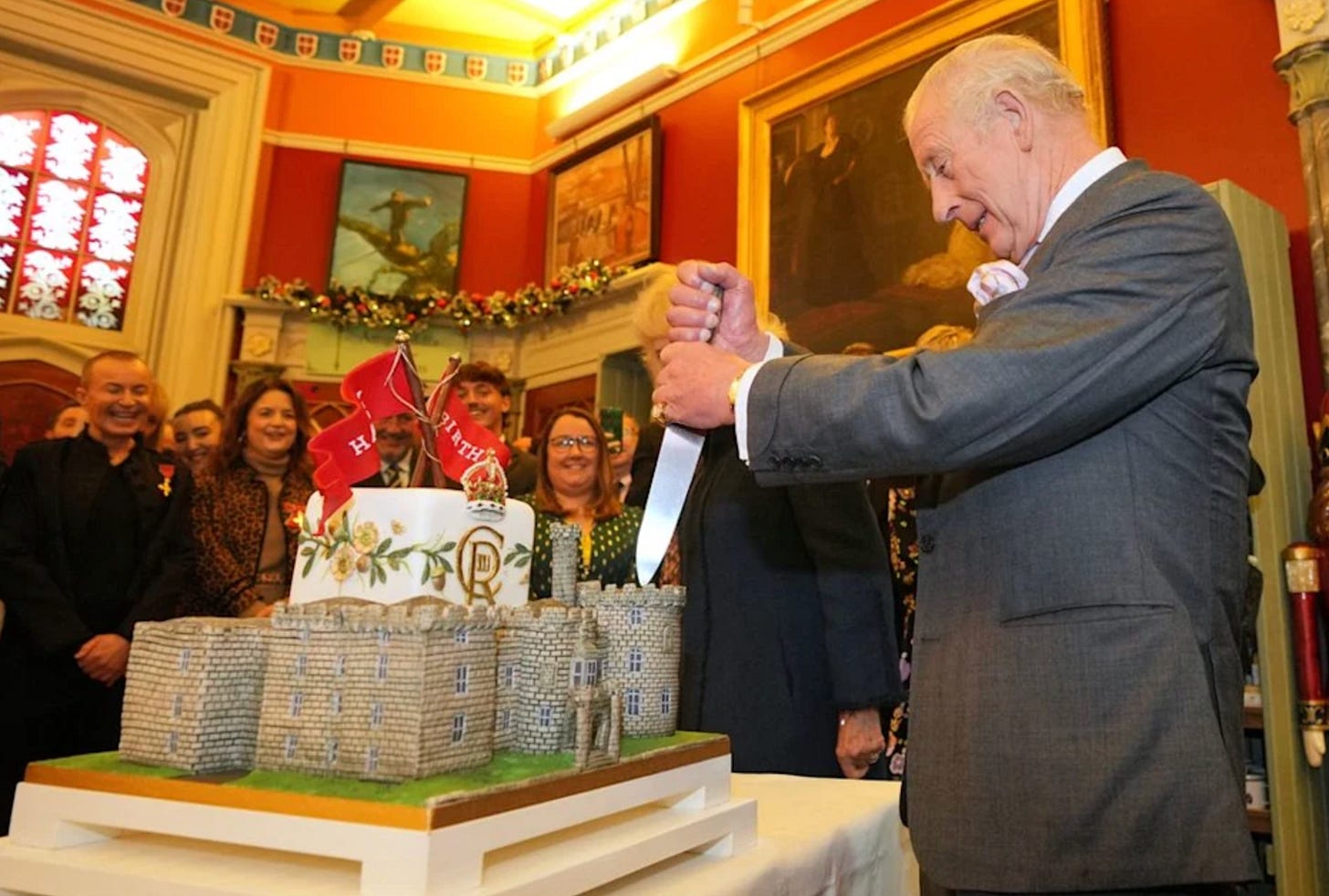 King Charles cutting his cake