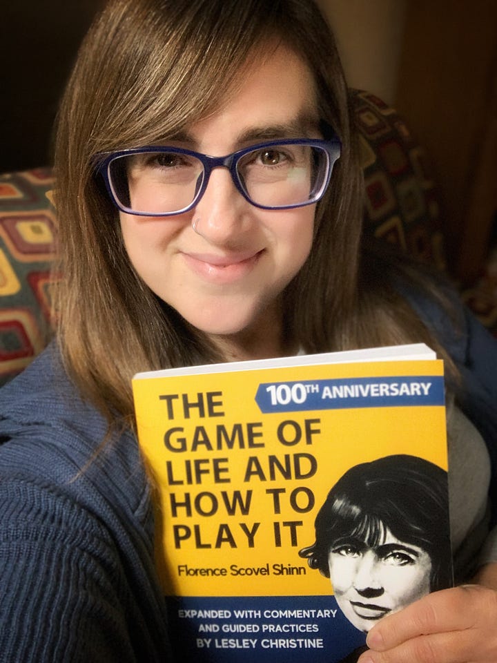 Girl holding book The Game of Life and How to Play It