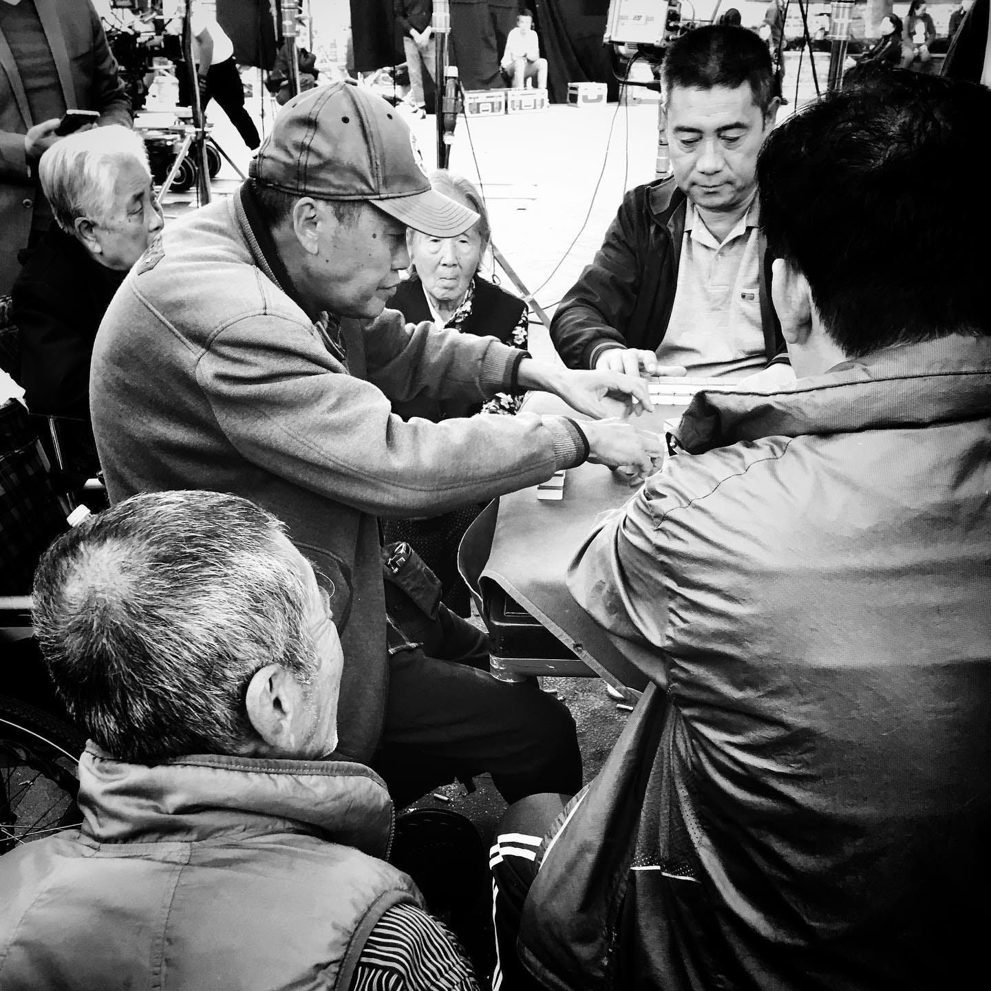 Neighbors playing mahjong on the street in a Beijing hutong Neighbors playing mahjong on the street in a Beijing hutong