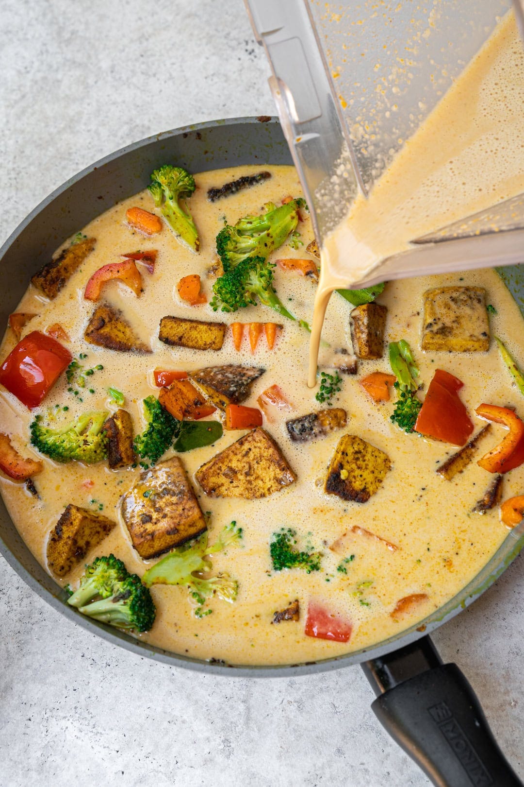 Adding peanut sauce to the pan