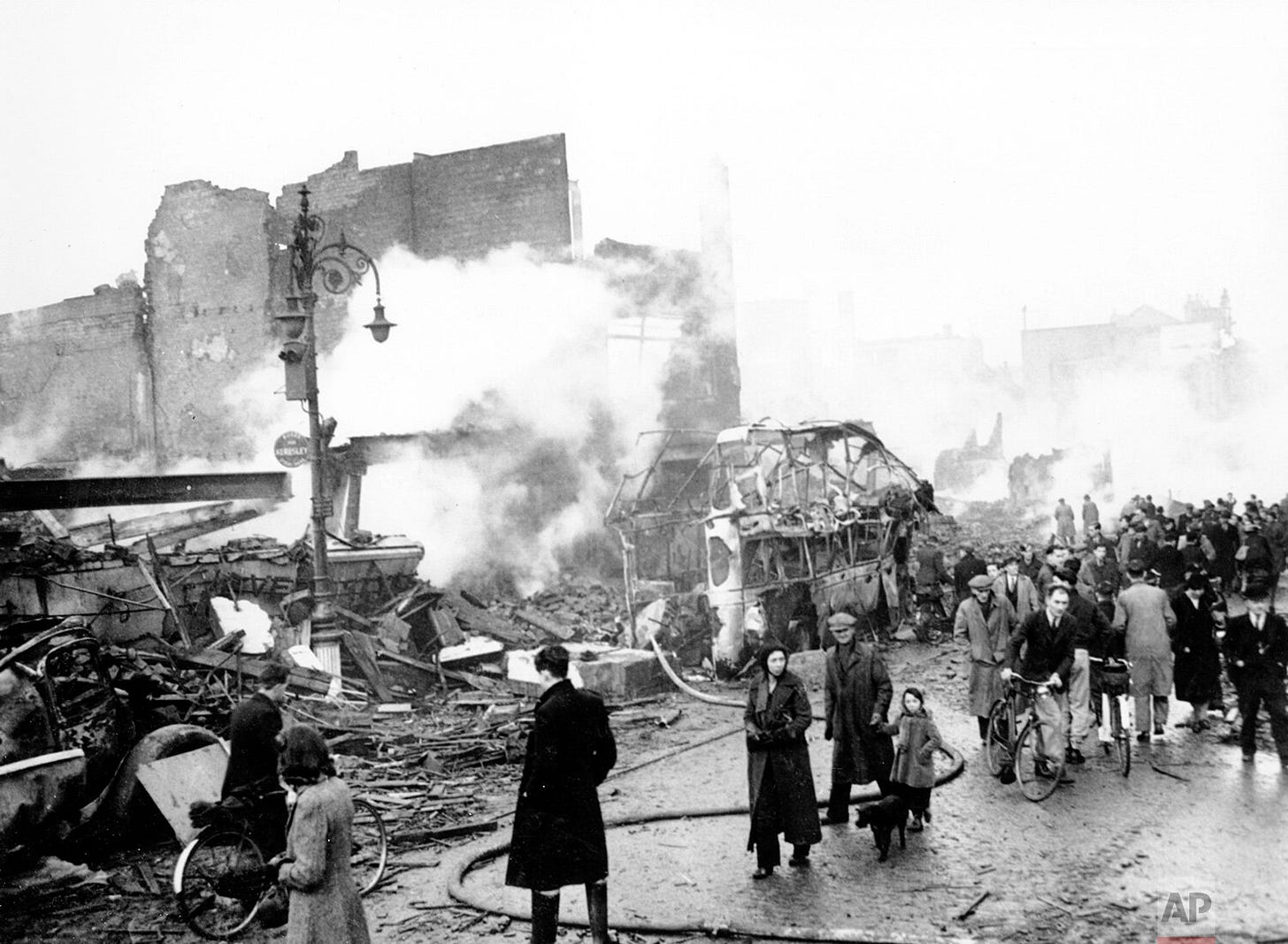 Residents navigate the devastated streets of Coventry, England, on November 14, 1940, after a devastating German bomb raid left widespread destruction across the city during the Blitz. Residents navigate the devastated streets of Coventry, England, on November 14, 1940, after a devastating German bomb raid left widespread destruction across the city during the Blitz.