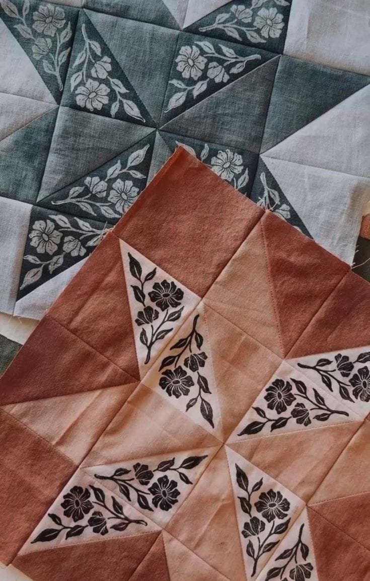 This may contain: an orange piece of cloth with black and white designs on it