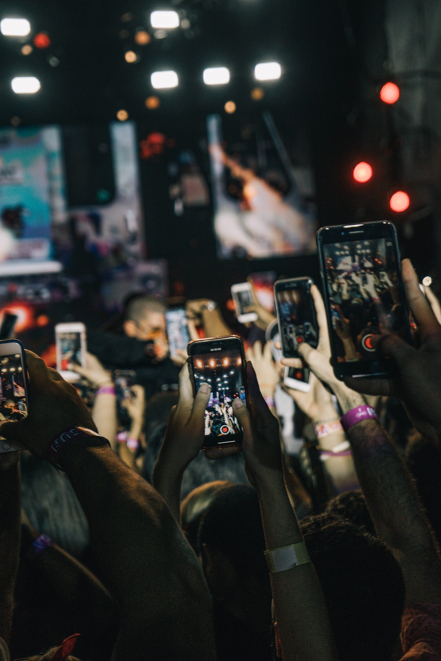 Photo of a crowd at a gig holding up their mobile phones to film the concert. You can see multiple screens showing what they are filming. Photo by Gian Cescon on Unsplash Photo of a crowd at a gig holding up their mobile phones to film the concert. You can see multiple screens showing what they are filming. Photo by Gian Cescon on Unsplash
