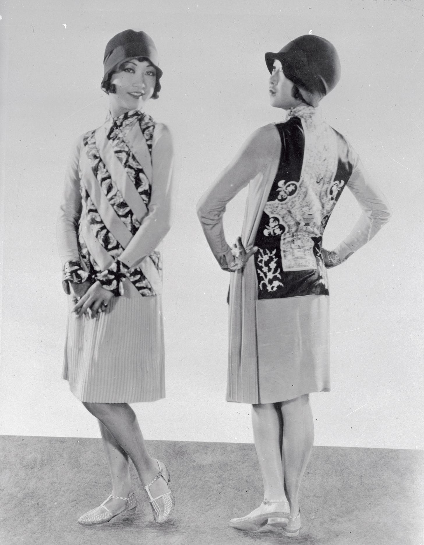 Two shots of AMW side by side, one from the front, one from behind, as she models her Asian inspired flapper dress and cloche hat. Two shots of AMW side by side, one from the front, one from behind, as she models her Asian inspired flapper dress and cloche hat.