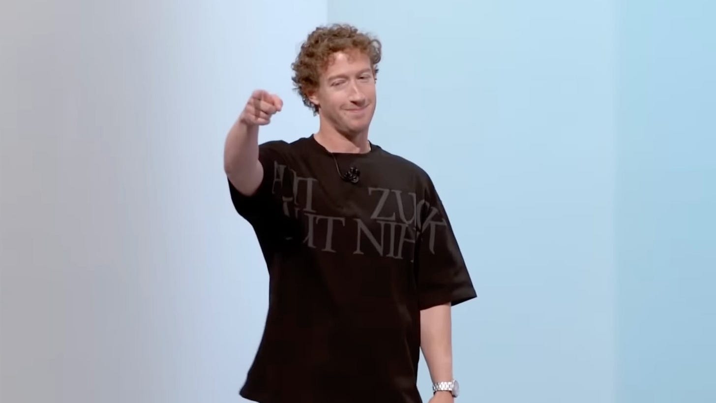 Mark Zuckerberg in a baggy shirt pointing to someone in the audience. Mark Zuckerberg in a baggy shirt pointing to someone in the audience.