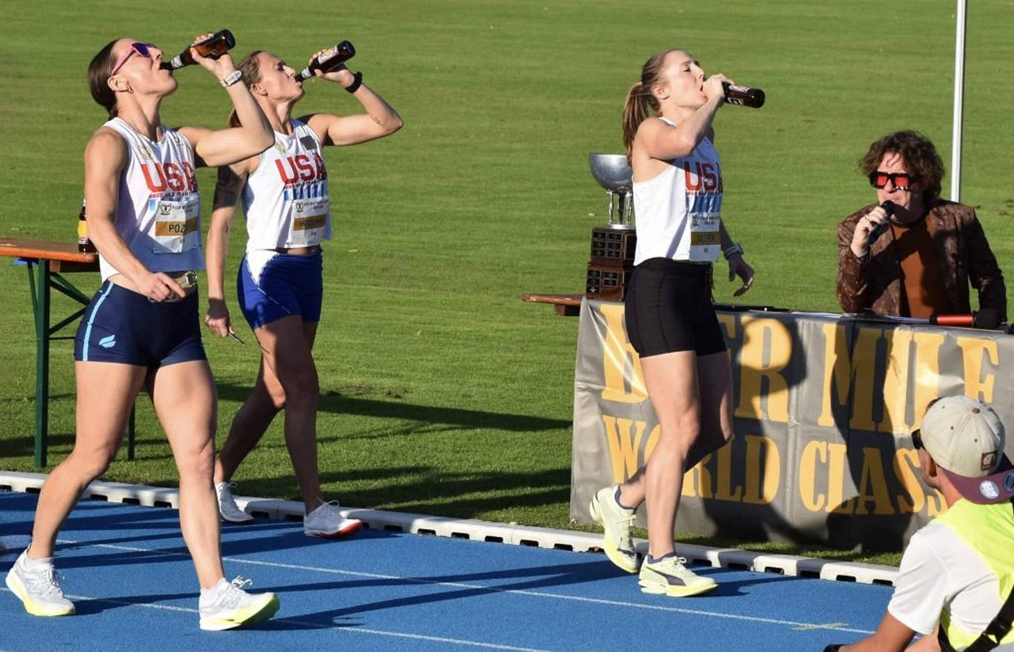 Elizabeth Laseter (front) and Shelby Houlihan (back) drinking beer during the 'chugging' section of the Beer Mile race Elizabeth Laseter (front) and Shelby Houlihan (back) drinking beer during the 'chugging' section of the Beer Mile race