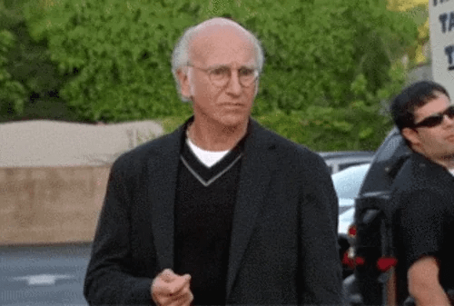 TV gif. On Curb Your Enthusiasm, Larry David weighs his options looking torn and shrugging as if he’s confused.