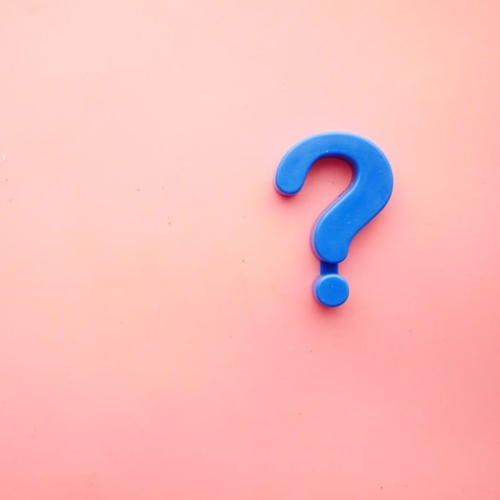 a blue question mark on a pink background a blue question mark on a pink background