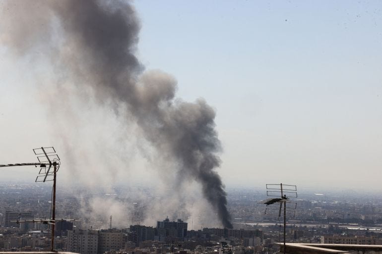 A plume of smoke rises following reported explosions in Tehran A plume of smoke rises following reported explosions in Tehran