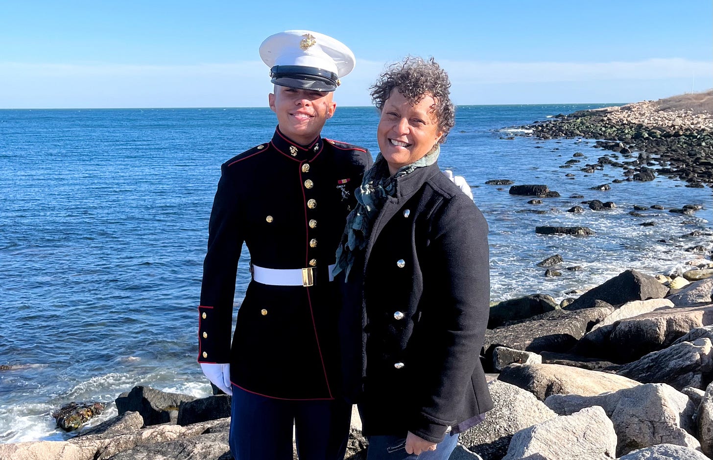 me standing on a rocky shoreline with my son wearing dress blues, both smiling