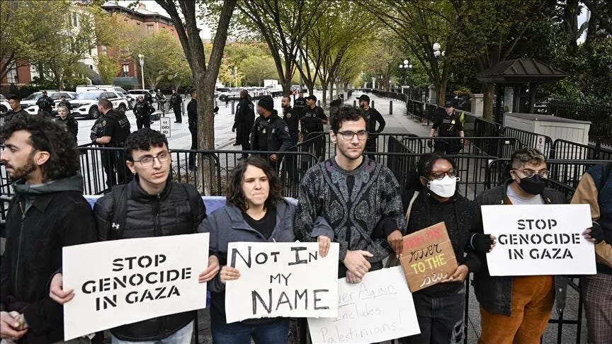 On October 17, 2023, anti-Zionist Jews and pro-Palestinian activists protest outside of the White House with signs saying “Stop Genocide in Gaza.”